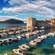A harbor filled with boats next to the coastal defensive walls of Dubrovnik